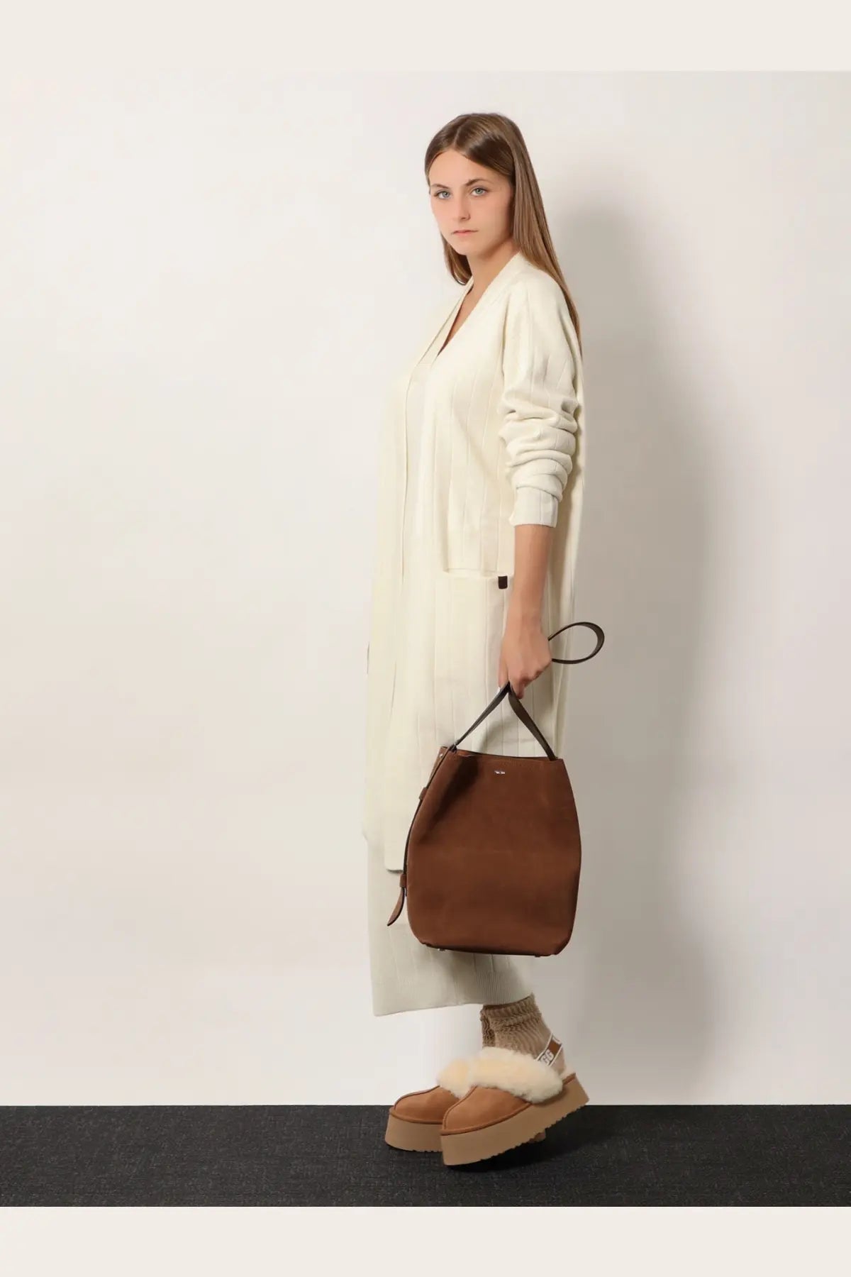Brown suede bucket bag with black handles paired with Max Mara women’s Giusto cashmere cardigan white