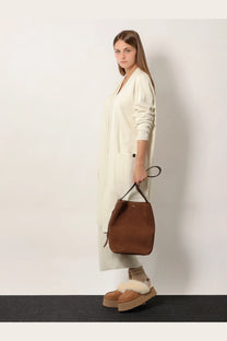 Brown suede bucket bag with black handles paired with Max Mara women’s Giusto cashmere cardigan white