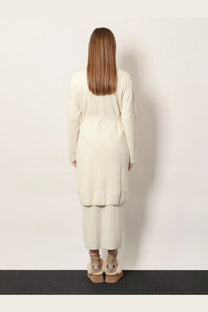 Cream-colored ribbed knit cashmere cardigan and matching wide-leg pants paired with ugg platform boots by max mara