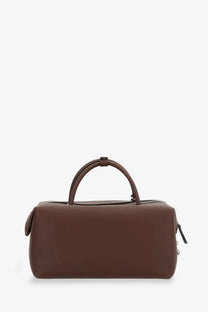 Max Mara women’s brown leather duffel bag with rounded top handles and zipper closures for holdall cargo use