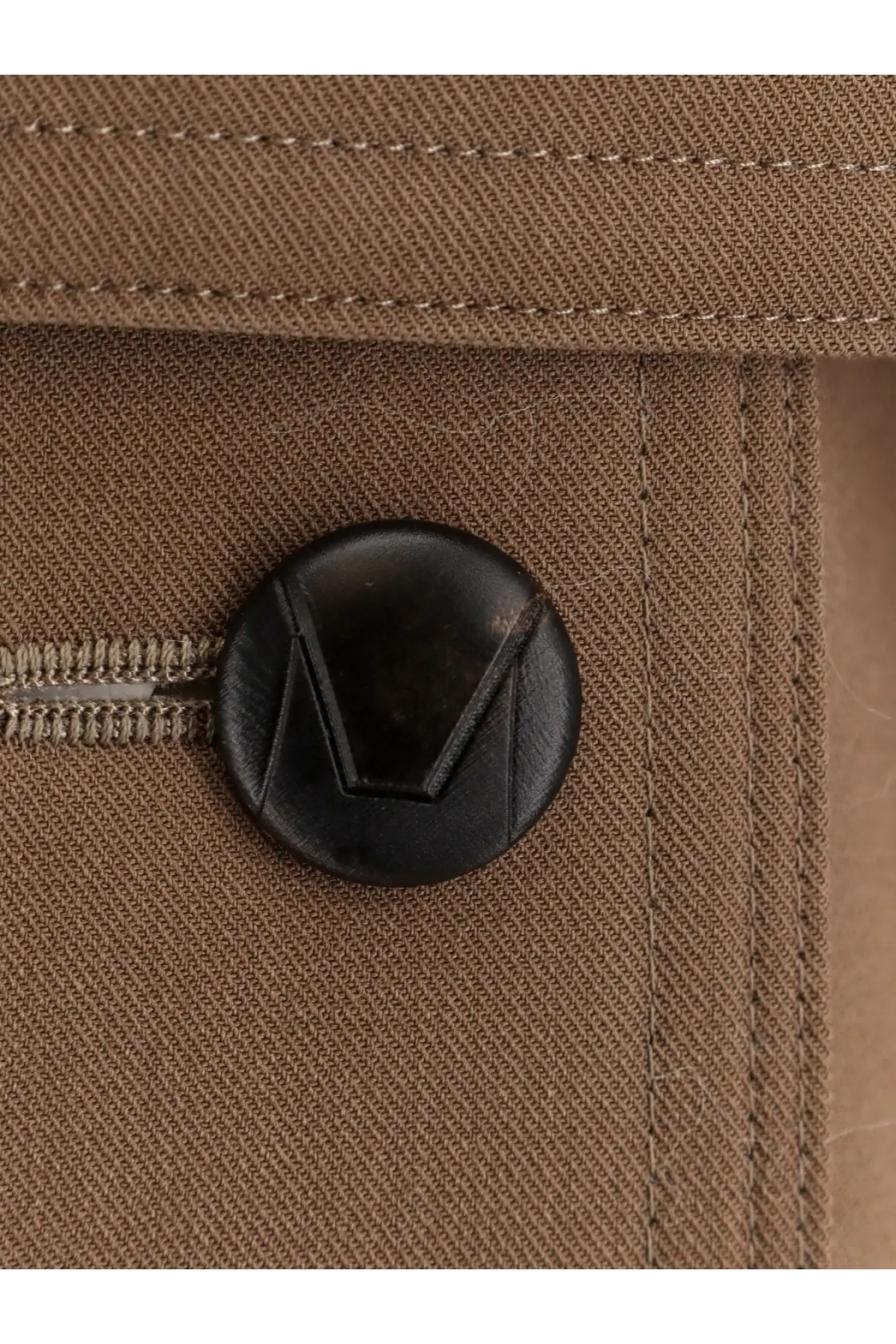 Black circular button with stitched v design on tan fabric of max mara women’s mxmcerto virgin wool brown trench coat