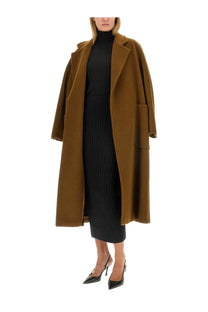 A rich brown longline wool coat with double-breasted design and wide lapels paired with max mara women’s black silk skirt