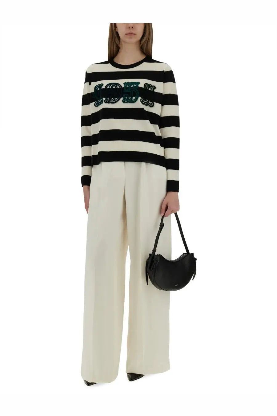Black crescent-shaped leather handbag with sleek minimalist design paired with max mara women’s wide pant white