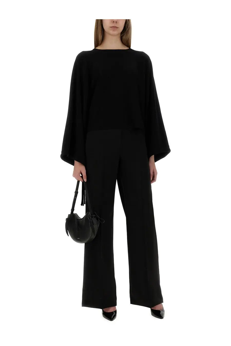 Black leather crescent-shaped handbag with tassel straps paired with max mara women’s wide pants fernet black