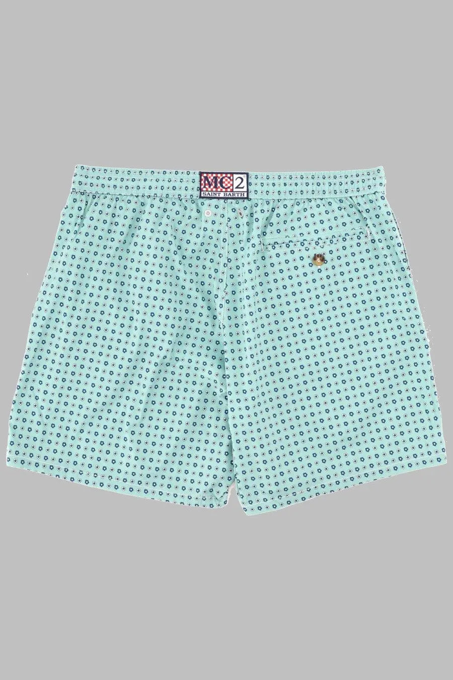Back side of light blue patterned swim trunks with elastic waistband and embroidered logo by mc2 saint barth