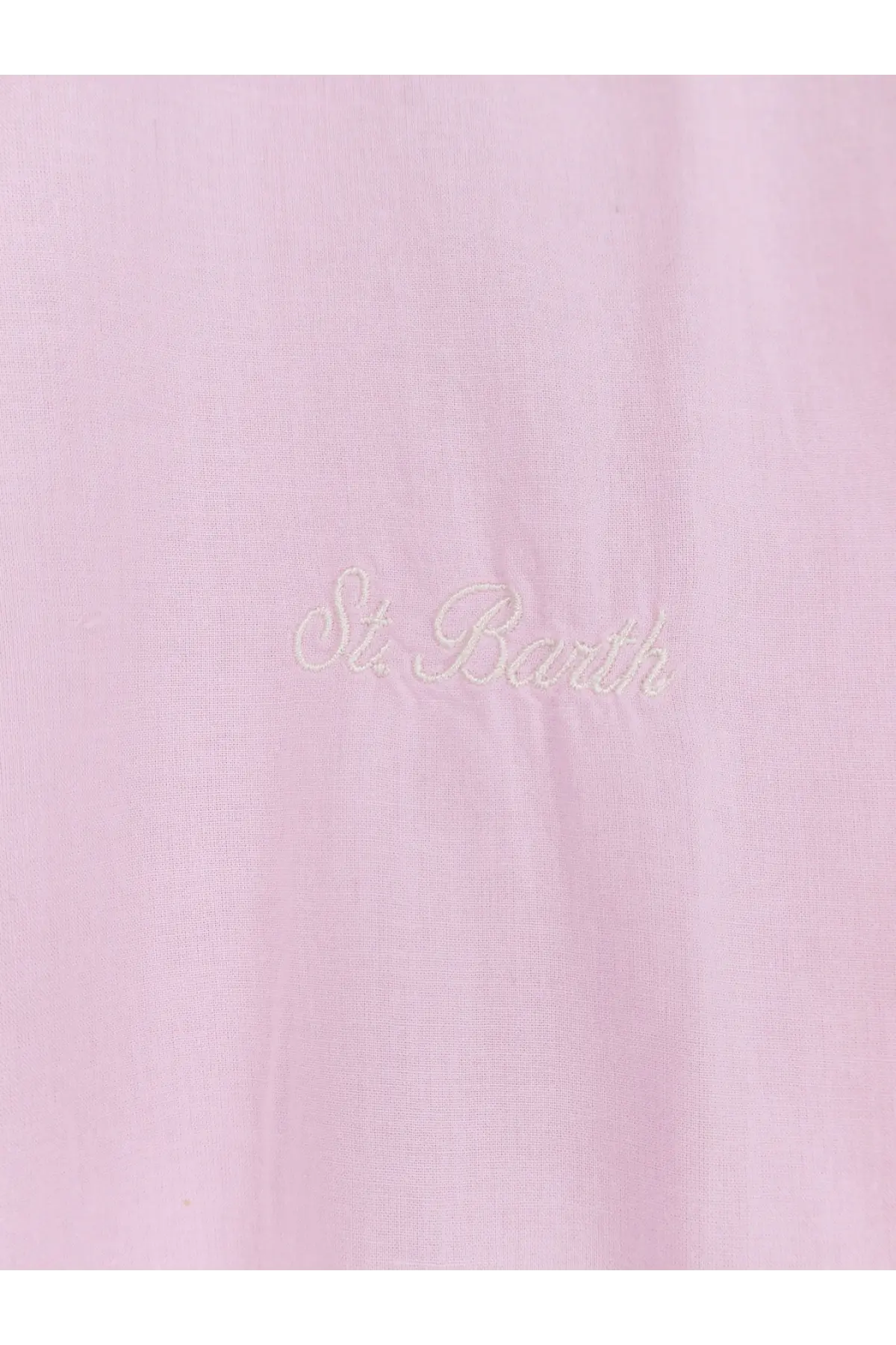 A soft pink cotton fabric with delicate white embroidery reading st on the back of a mc2 saint barth men’s shirt