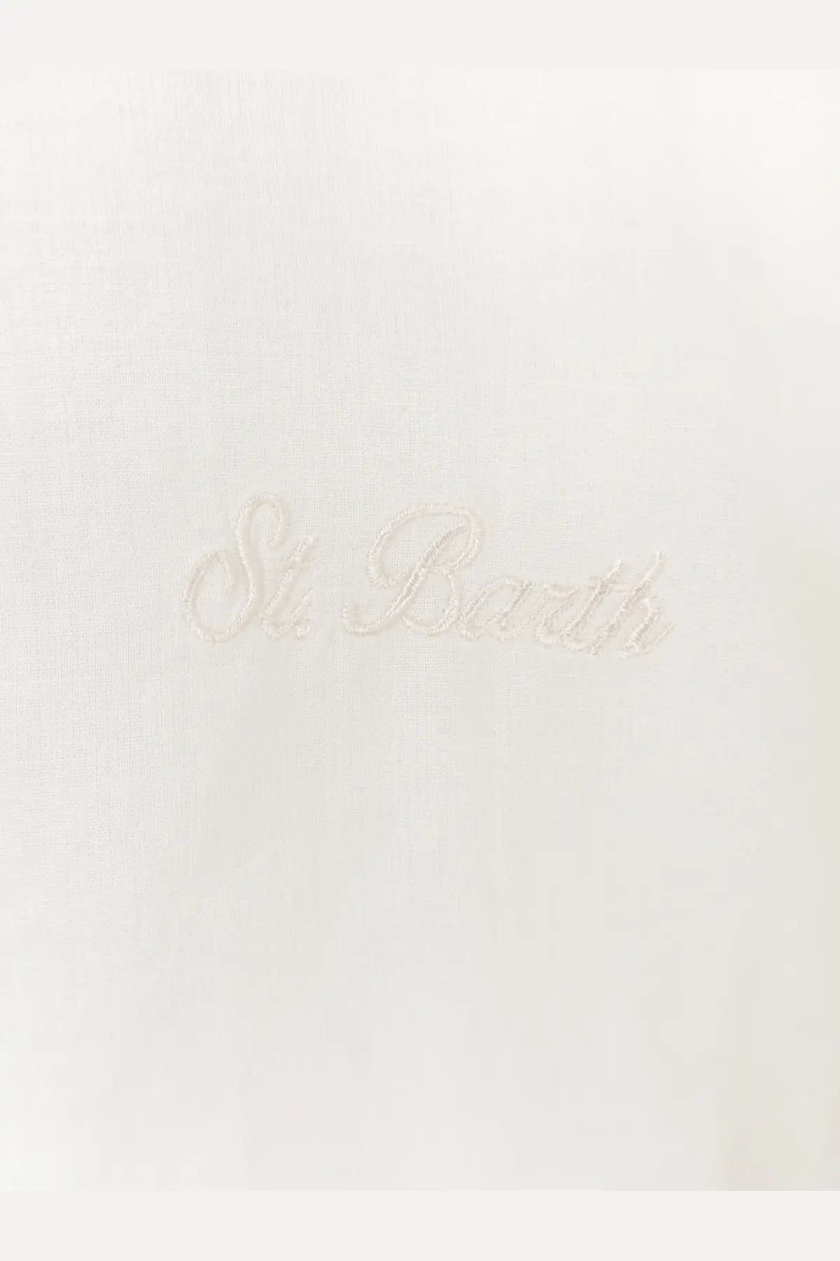 A delicate white embroidered patch with st on a mc2 saint barth men’s white cotton shirt