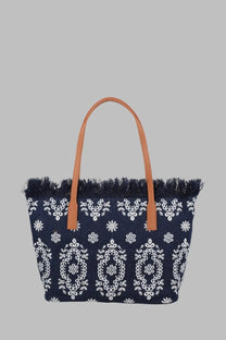 Navy blue woven tote bag with white floral embroidery tan leather handles and fringed top edge by Mc2 Saint Barth