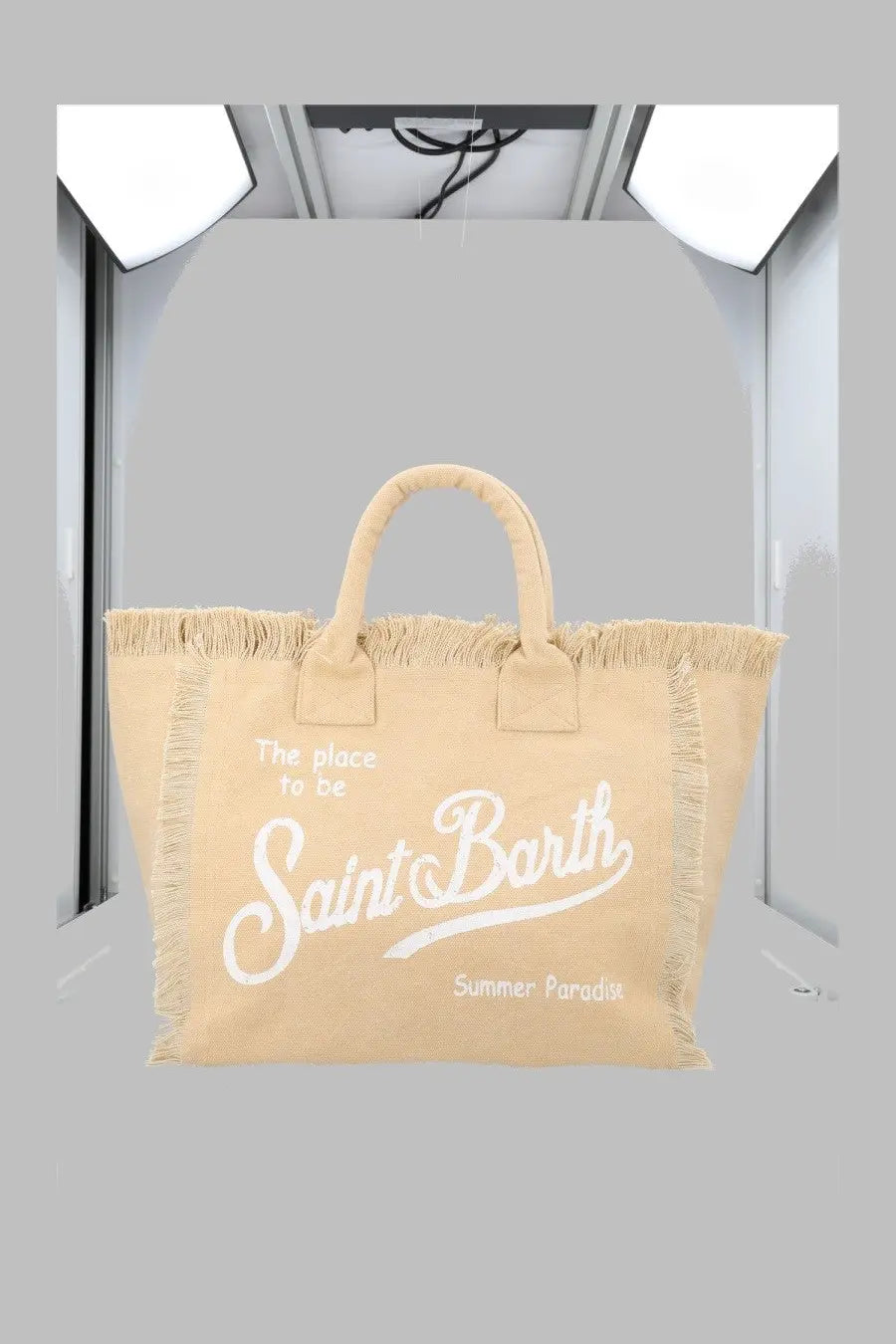 Beige canvas tote bag with white frayed edges and handles featuring saint barth cursive and summer paradise print