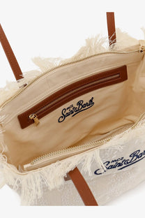 Cream-colored woven canvas tote bag with frayed edges brown leather handles and navy logo interior by mc2 saint barth