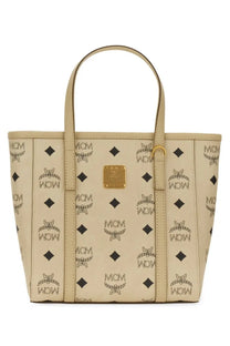 Beige mcm women’s borsa shopper toni mini tote bag with repeating black logo and diamond pattern gold-tone hardware