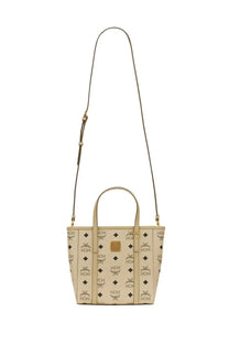 Beige mcm women’s borsa shopper toni mini tote bag with repeating gold toned logo pattern and matching handles