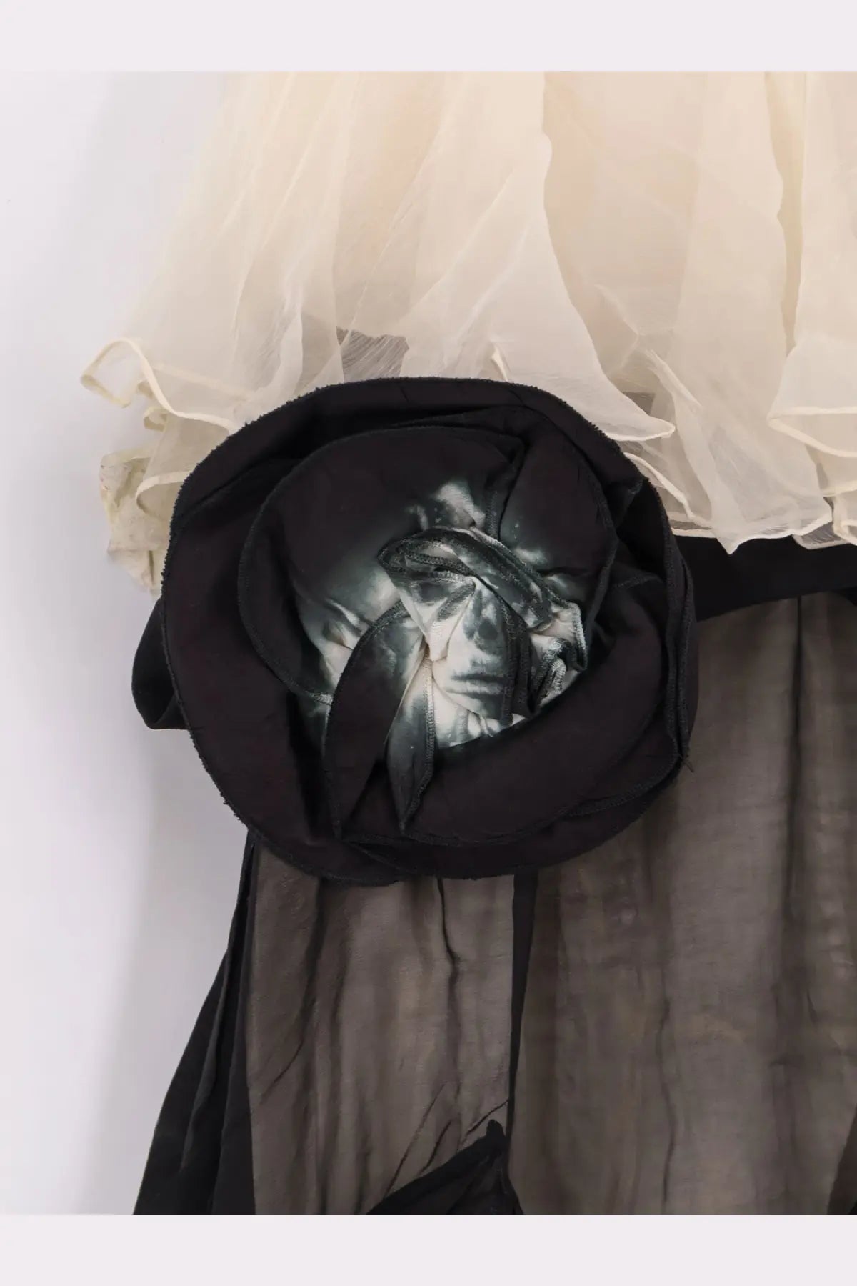 A black fabric rose brooch with a glossy reflective center on mes demoiselles women’s belvy long viscose dress black