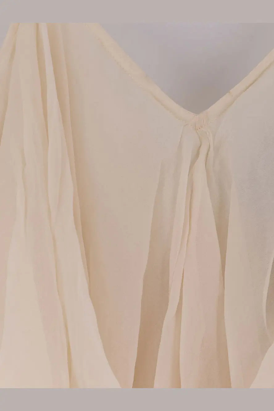 Cream-colored lightweight vestito lungo with soft v-neckline and subtle pleats made of viscosa white by mes demoiselles