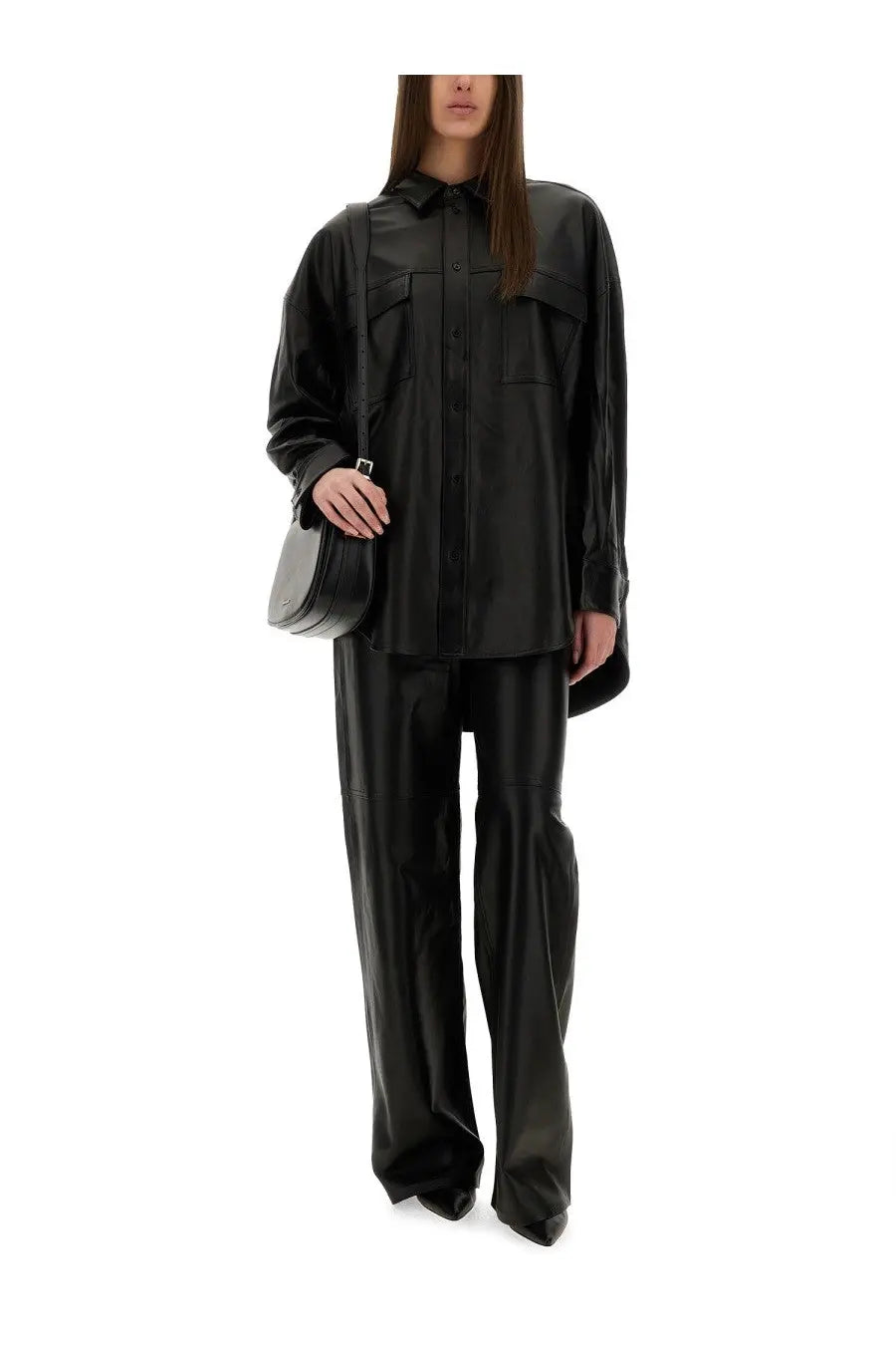 Black faux leather oversized shirt with button front and flap pockets styled with michael kors women’s leather pants black