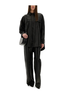 Black faux leather oversized shirt with button front and flap pockets styled with michael kors women’s leather pants black