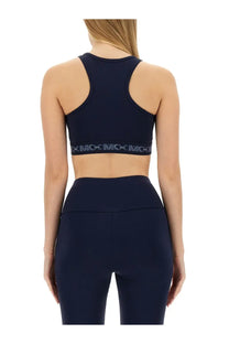 Navy blue michael kors women’s sports bra with black elastic band featuring repeating mcc logo text