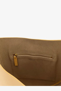 Beige leather interior of minobossi women’s lizzie leather crossbody bag green with gold-tone zipper and pull tab