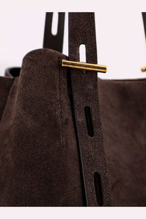 Minobossi women’s Paula suede shoulder bag in brown with a gold-tone metal bar closure and bucket style design