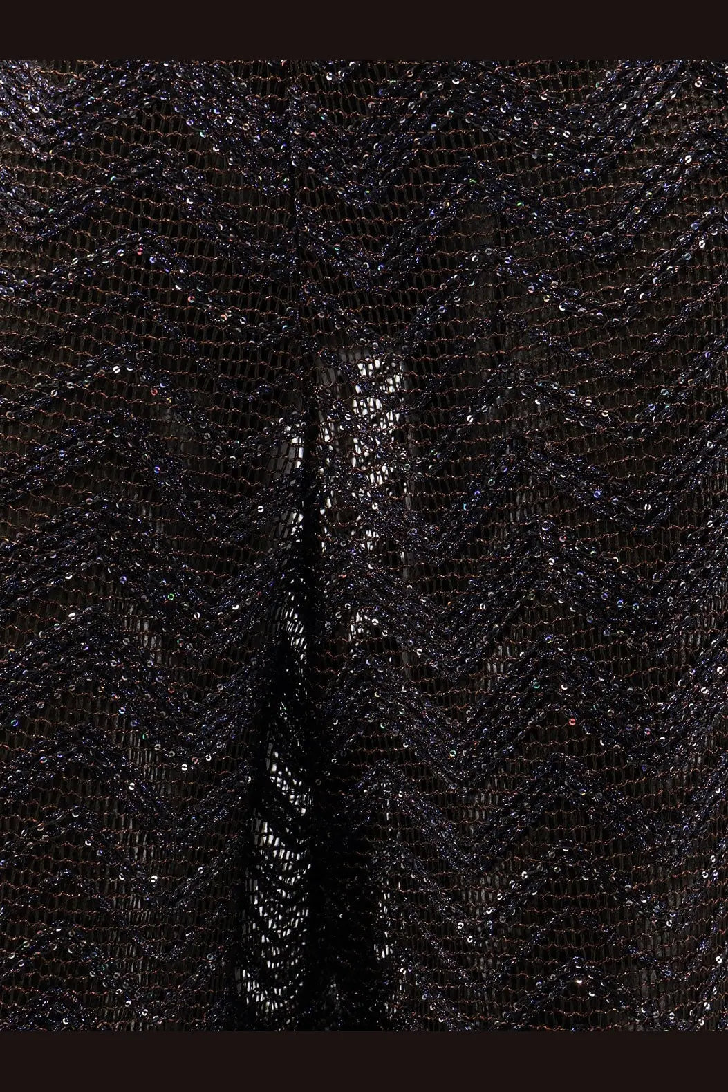 Black sequined mesh fabric with a shimmering textured pattern shown with missoni womens viscose blend brown trousers