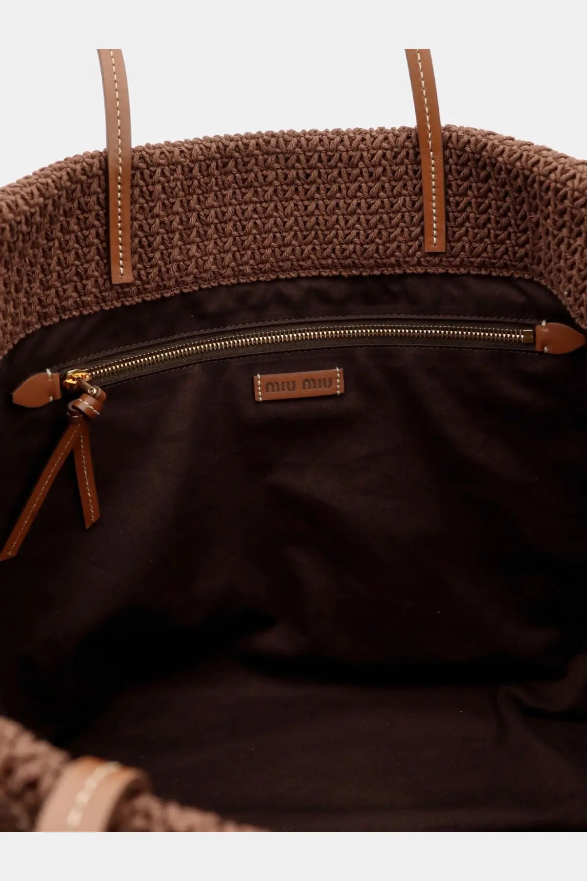 Miu Miu women’s brown woven crochet tote bag with tan leather handles, black lining, and gold-tone zipper hardware