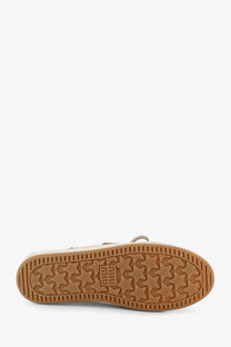Beige suede low-top sneaker with tan rubber sole embossed with star pattern and puma logo for women