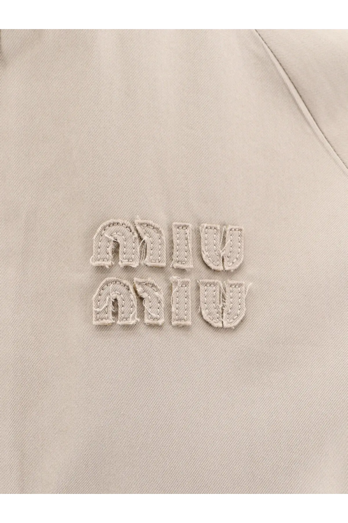 Beige miu miu embroidered logo patch on green old twill fabric of miu miu womens jacket
