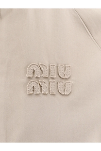 Beige miu miu embroidered logo patch on green old twill fabric of miu miu womens jacket