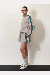Miu miu women’s old twill jacket green featuring a gray athletic tracksuit set with teal stripes and high collar details