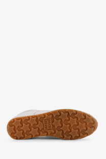 Miu Miu women’s plume white leather high-top sneaker with tan rubber sole and star-shaped tread pattern