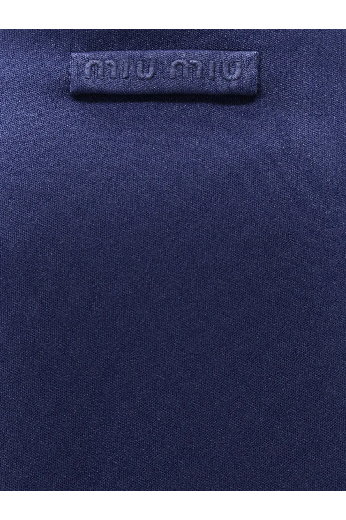 Dark blue miu miu fabric label with embossed logo on miu miu women’s baltico skirt