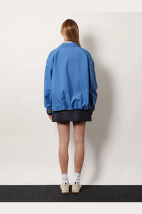 Miu Miu women’s blue bomber jacket in technical fabric with black trim and relaxed oversized fit