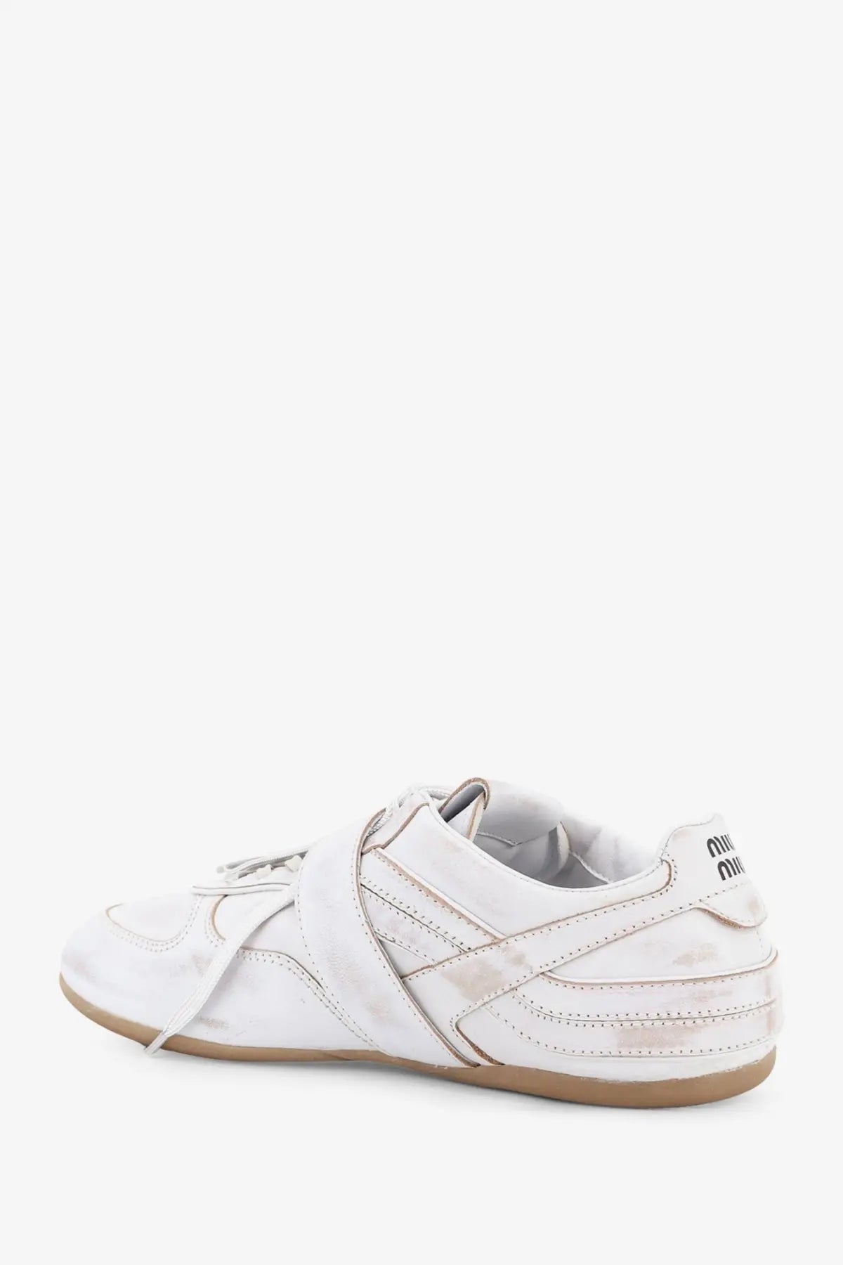 Miu Miu women’s white leather sneakers with used effect distressed finish and tan rubber sole