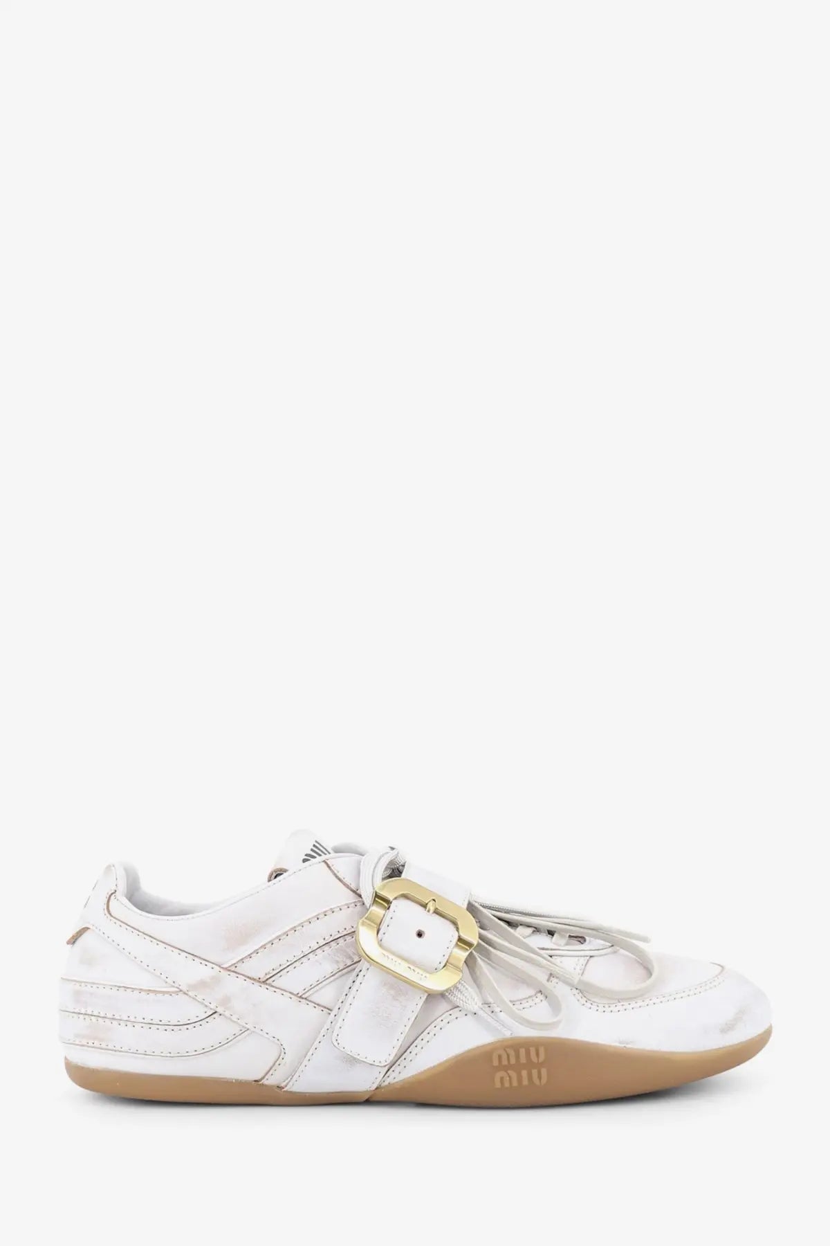 Miu miu women’s white leather sneakers with gold-tone buckle and tan rubber sole showing used effect