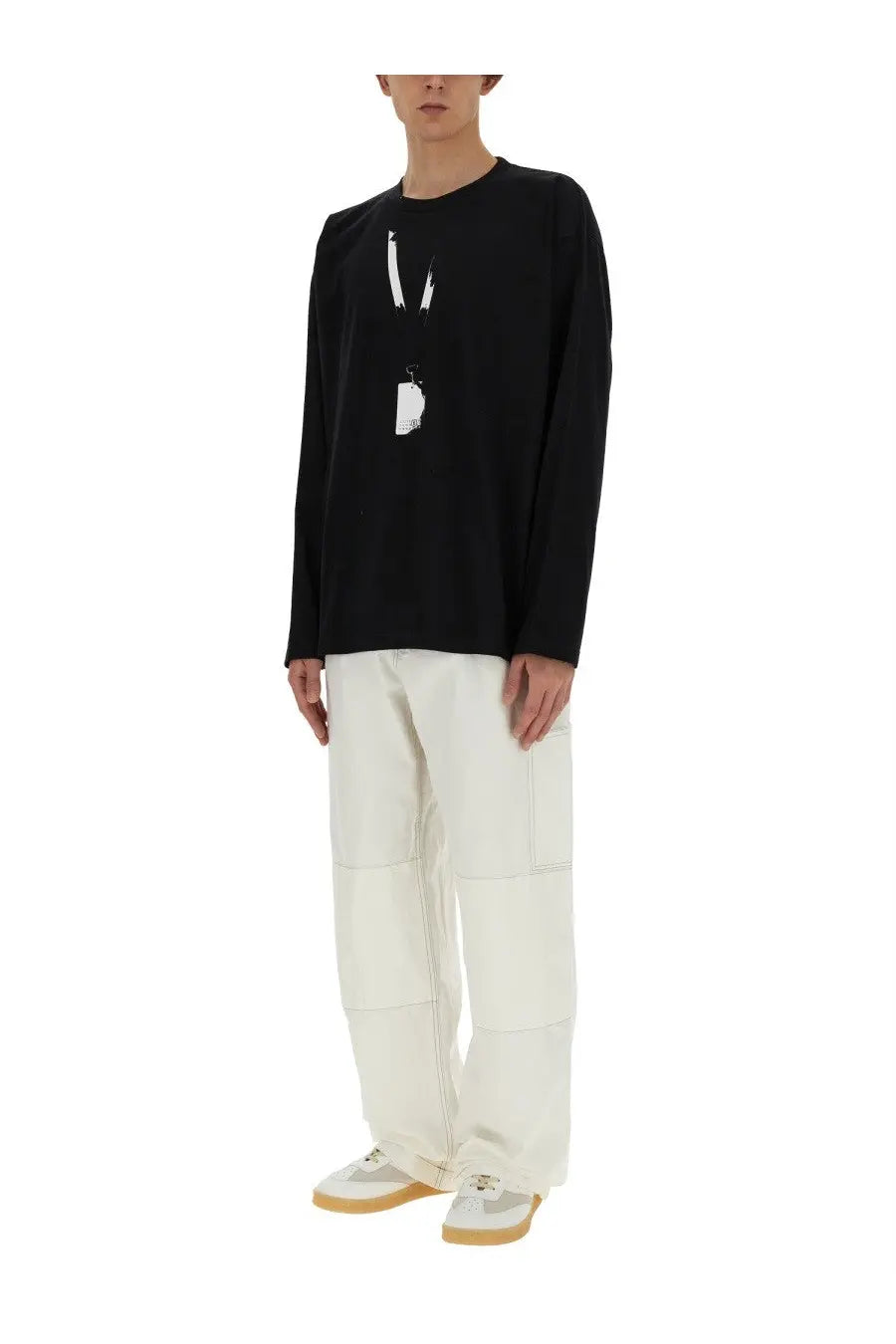 Black long-sleeved cotton top with white graphic print paired with mm6 maison margiela men’s white cotton canvas pants