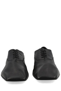 Black leather lace-up oxford shoes with sleek minimalist design from mm6 maison margiela for men
