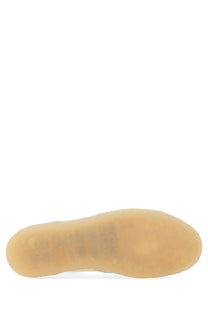 The sole of a tan rubber mm6 maison margiela men’s sneaker court white with smooth translucent finish and embossed branding