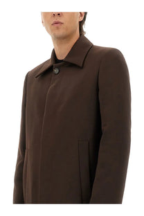 A sleek dark brown wool blend coat with structured collar and subtle stitching by MM6 Maison Margiela men’s collection