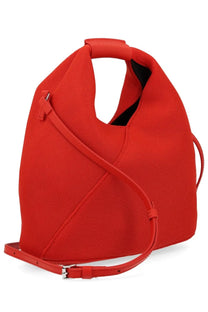 Vibrant red woven canvas tote bag with structured asymmetrical design and matching leather straps from MM6 Maison Margiela
