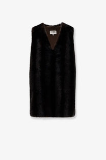 Black faux fur vest with v neckline and plush texture paired with mm6 maison margiela women’s brown faux shearling short dress