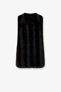 Black faux fur vest with sleek sleeveless design and soft plush texture paired with mm6 maison margiela brown faux shearling dress