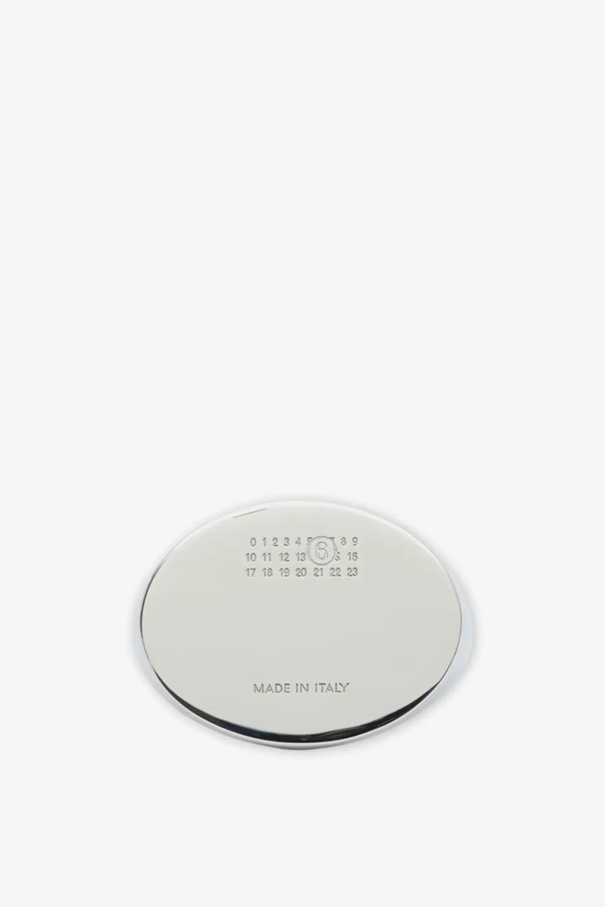 Chrome finished oval shaped metal coaster with engraved size markings and made in italy text for mm6 maison margiela ring