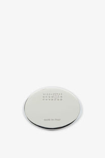 Chrome finished oval shaped metal coaster with engraved size markings and made in italy text for mm6 maison margiela ring