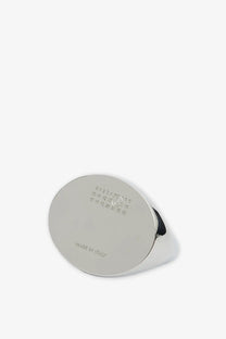 A sleek oval-shaped silver metal ring by MM6 Maison Margiela with polished finish and made in Italy engraving