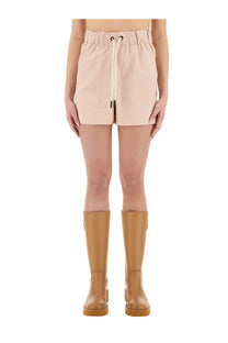 Beige high-waisted cotton gabardine shorts with drawstring waist and front pockets from Moncler Grenoble women’s collection