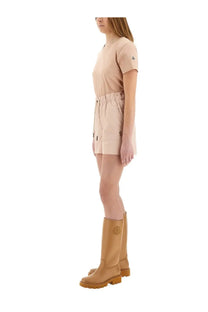 Tan leather knee-high boots with circular logo on the side paired with moncler grenoble women’s blue cotton gabardine shorts