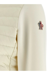 Moncler Grenoble women’s cream-colored quilted neoprene puffer jacket with red white and blue logo patch on sleeve