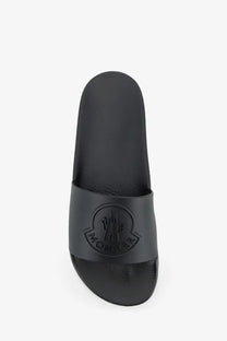 Black moncler men’s basile rubber slide sandal with matte finish and embossed logo on strap