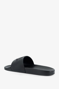 Black rubber slide sandal by moncler with minimalist design and subtle embossed logo on the strap