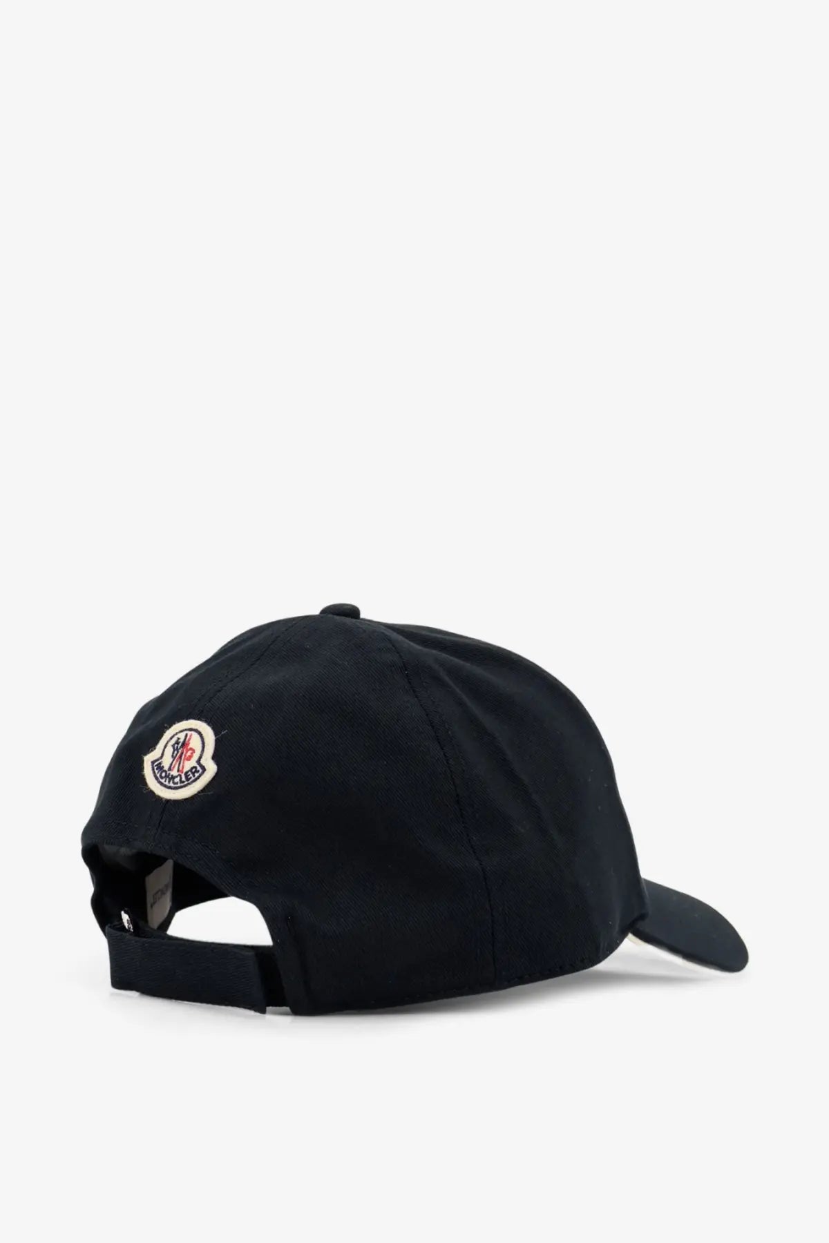 Image of the back side of a black moncler men’s cotton baseball hat with a circular embroidered logo on the back